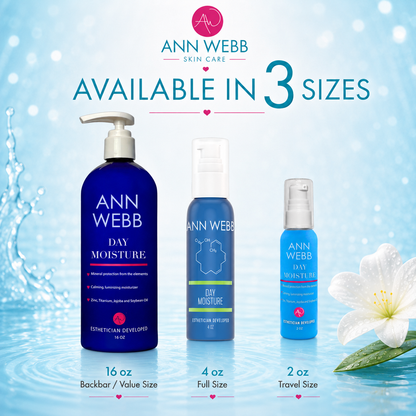 Three Ann Webb Day Moisture skincare bottles in different sizes (16 oz, 4 oz, and 2 oz) displayed against a light blue water splash background with a white flower and text indicating availability in 3 sizes.