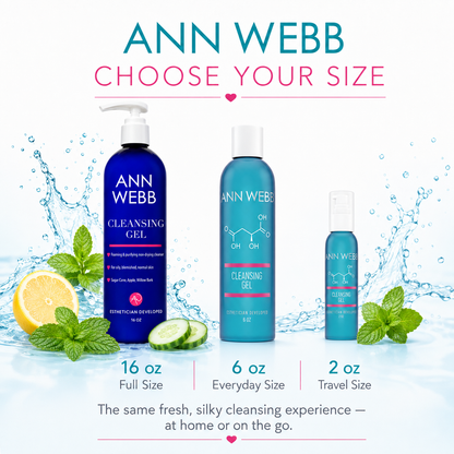 Three Ann Webb cleansing gel bottles in different sizes are shown on a white background with water splash graphics, lemon, mint, and cucumber slices. Text reads 'ANN WEBB CHOOSE YOUR SIZE' and indicates 16 oz full size, 6 oz everyday size, and 2 oz travel size.