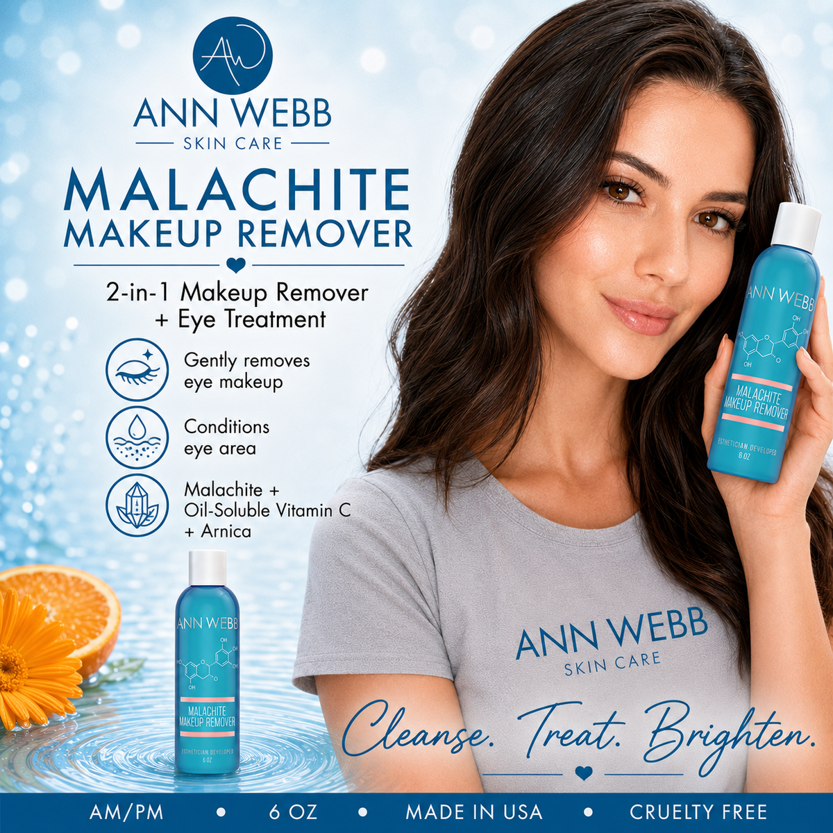 A woman holds a bottle of Ann Webb Skin Care Malachite Makeup Remover next to a large product label on a light blue background. She is wearing a gray t-shirt with the brand name printed on it, and an orange slice and flower are visible in the lower left corner.